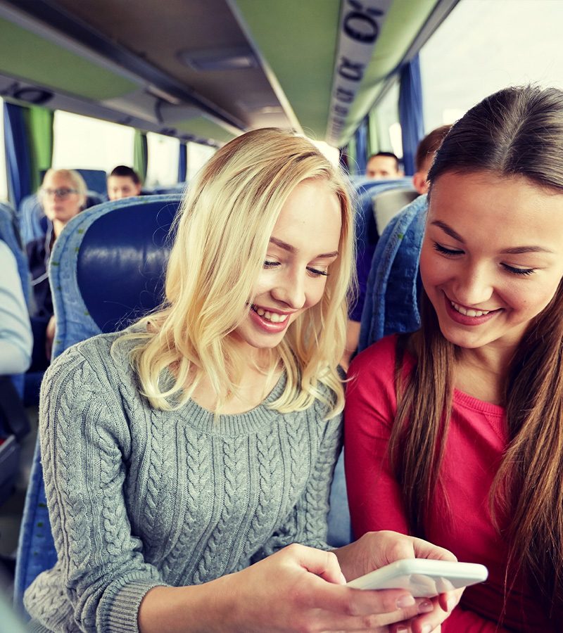 2-Girls-Riding-on-Bus-Smiling-1.jpg